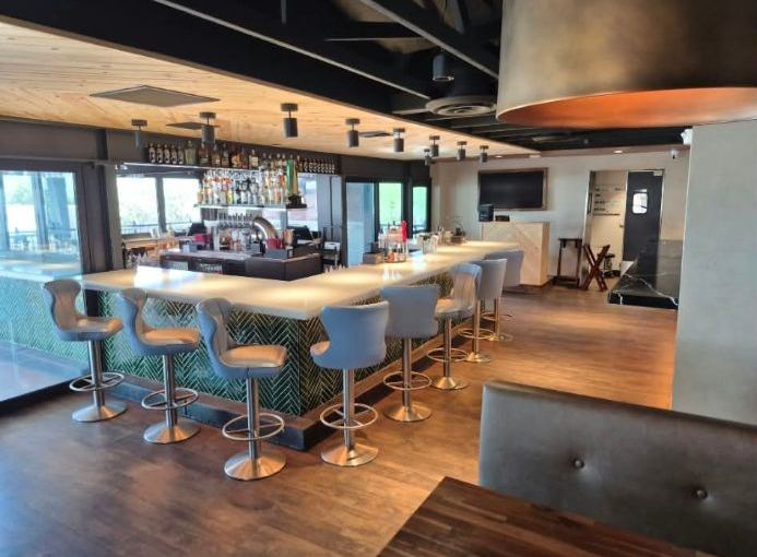 Restaurant bar with a long counter and stools