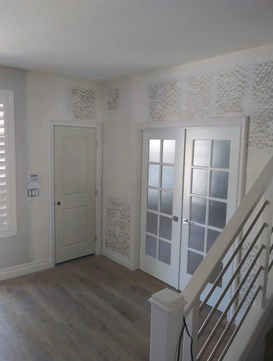 Entry with new casing, an interior door and French doors, walls mid-patch